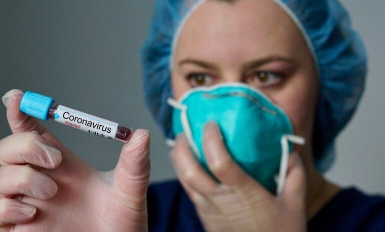 nurse holding coronavirus sample